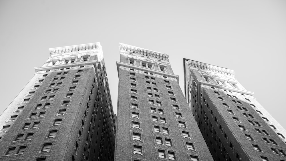 a black and white photo of two tall buildings