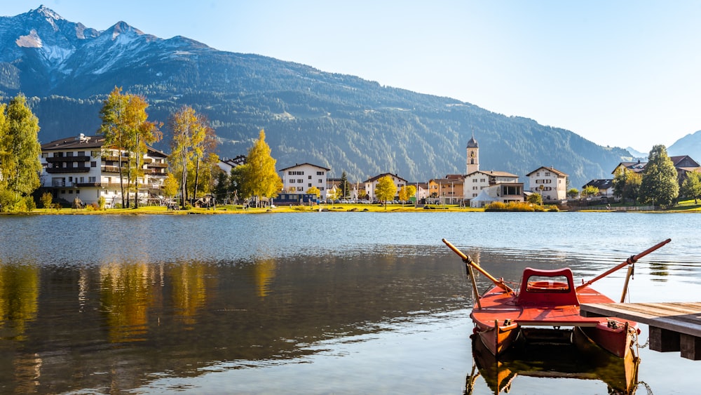 a boat is docked on a lake with a mountain in the background