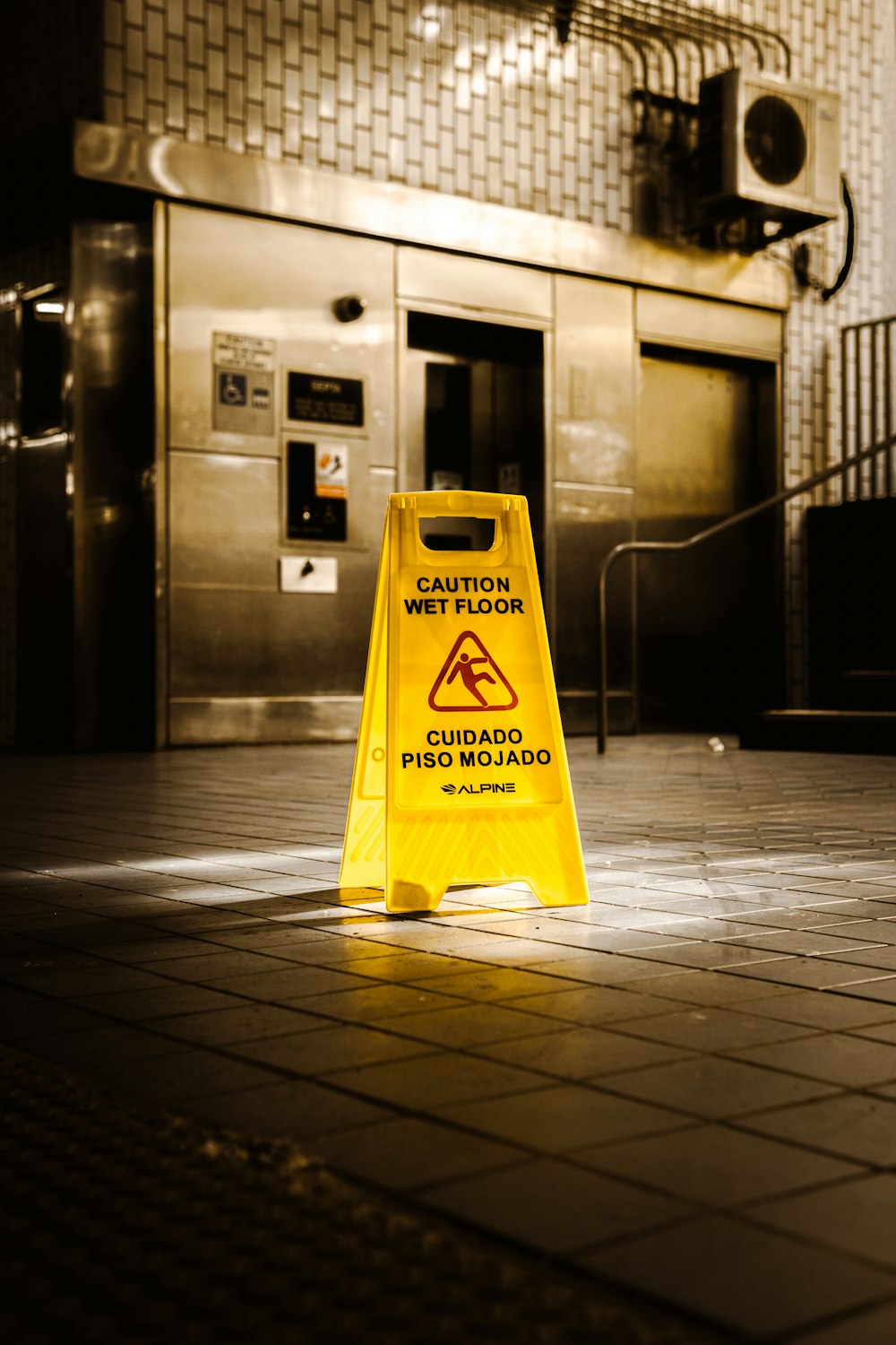 a caution sign sitting on the ground in front of a building