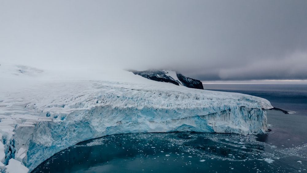 a large iceberg floating on top of a body of water