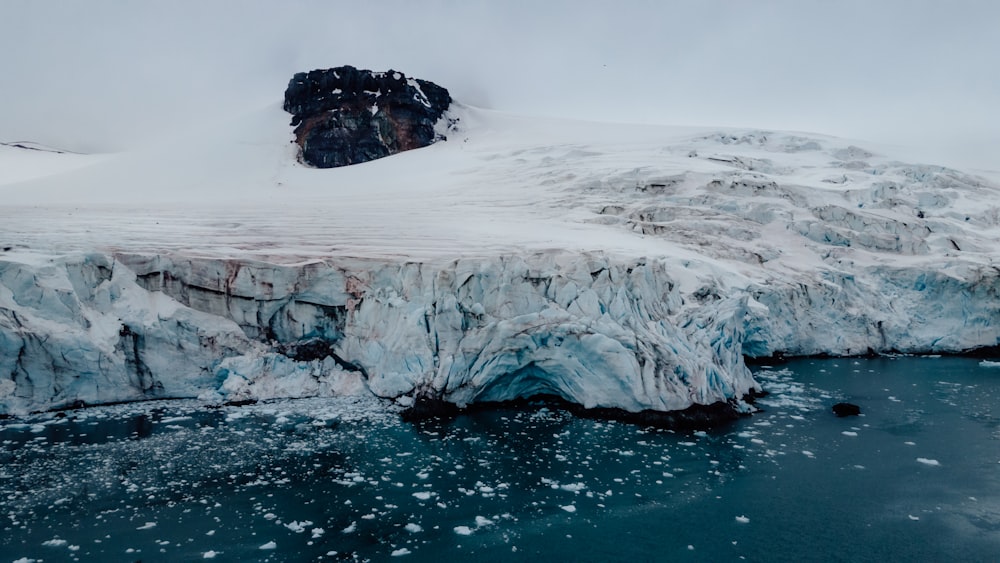 a large iceberg with snow on top of it