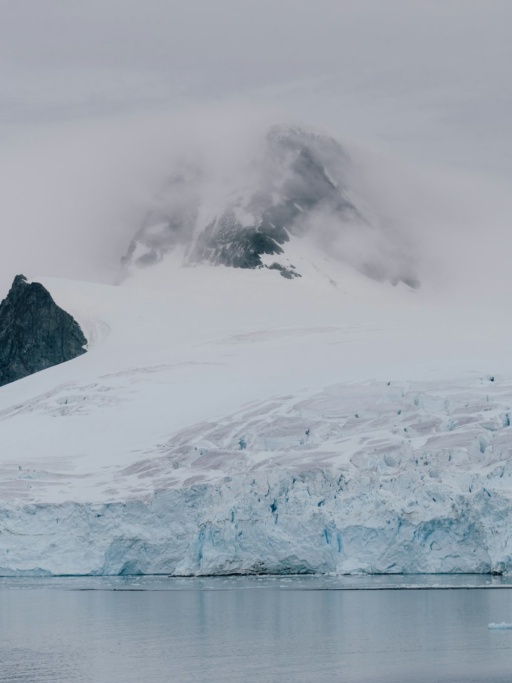 a large iceberg in the middle of a body of water