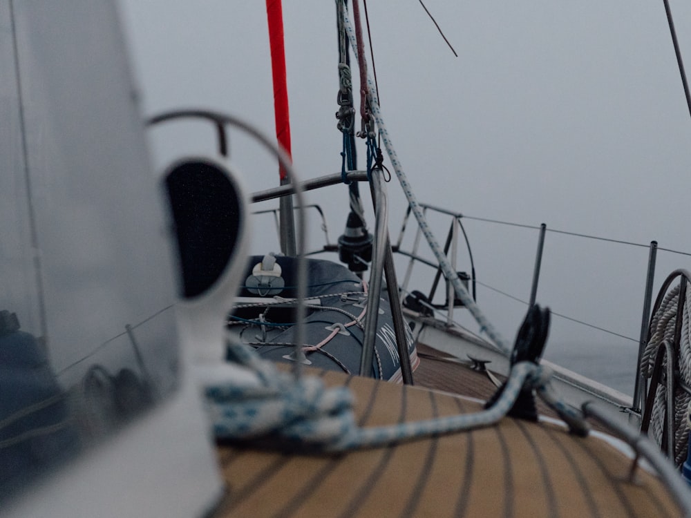 a view of the deck of a sailboat on a foggy day