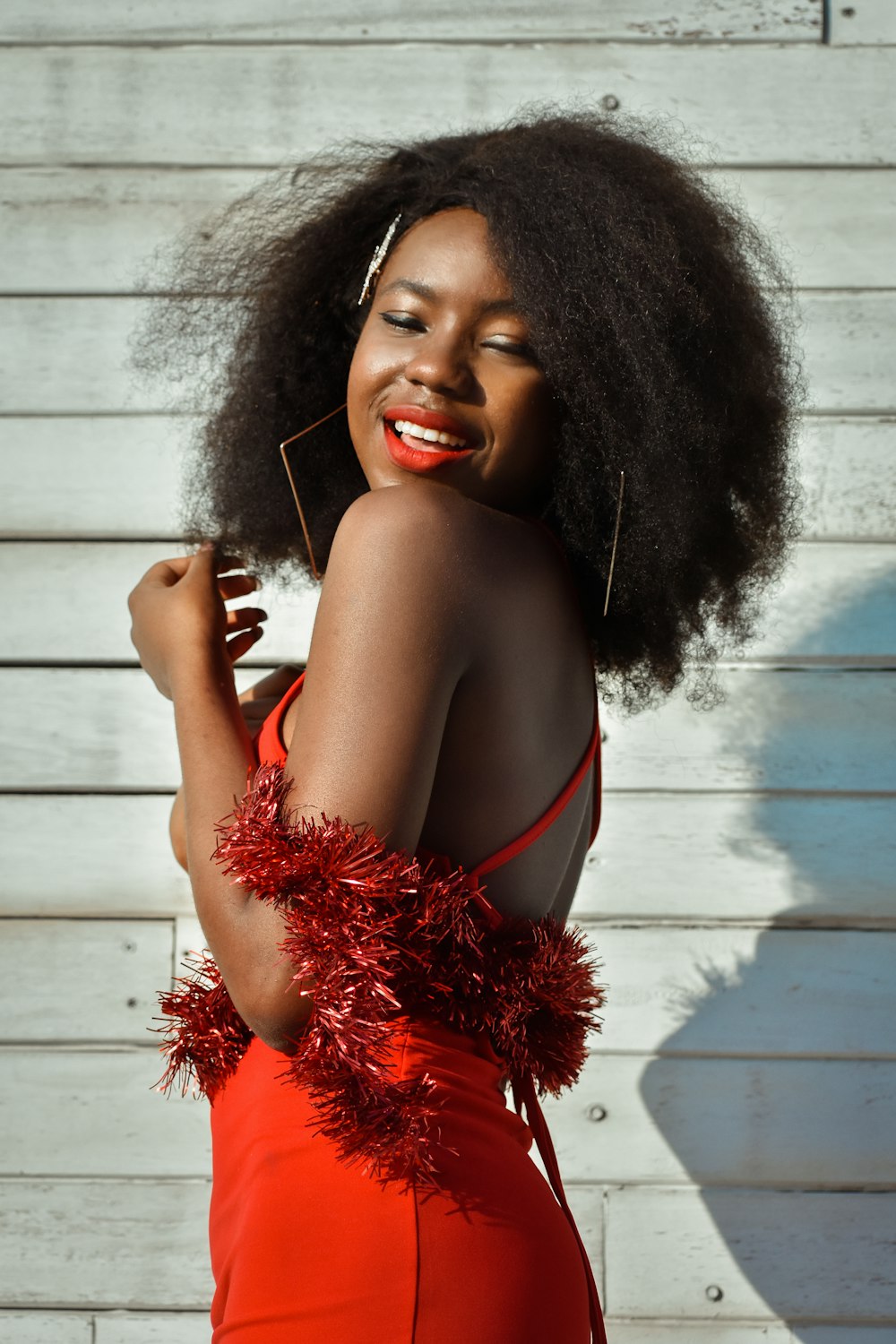 a woman in a red dress posing for a picture