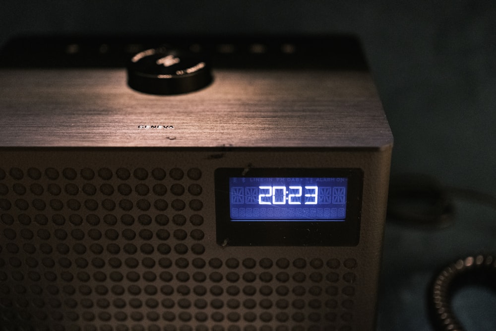 a clock that is on top of a radio