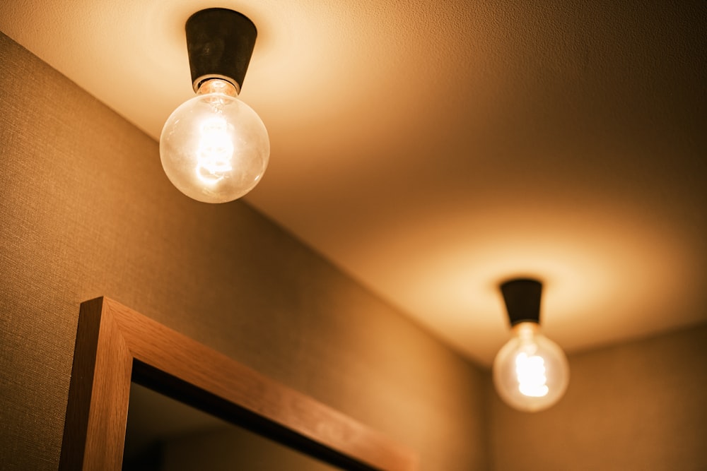 a bathroom with two light bulbs on the ceiling