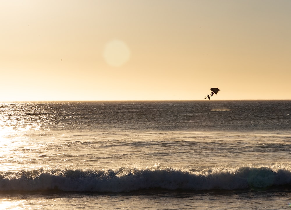 a person riding a surfboard on a wave in the ocean