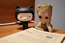 a book and a small figurine on a desk