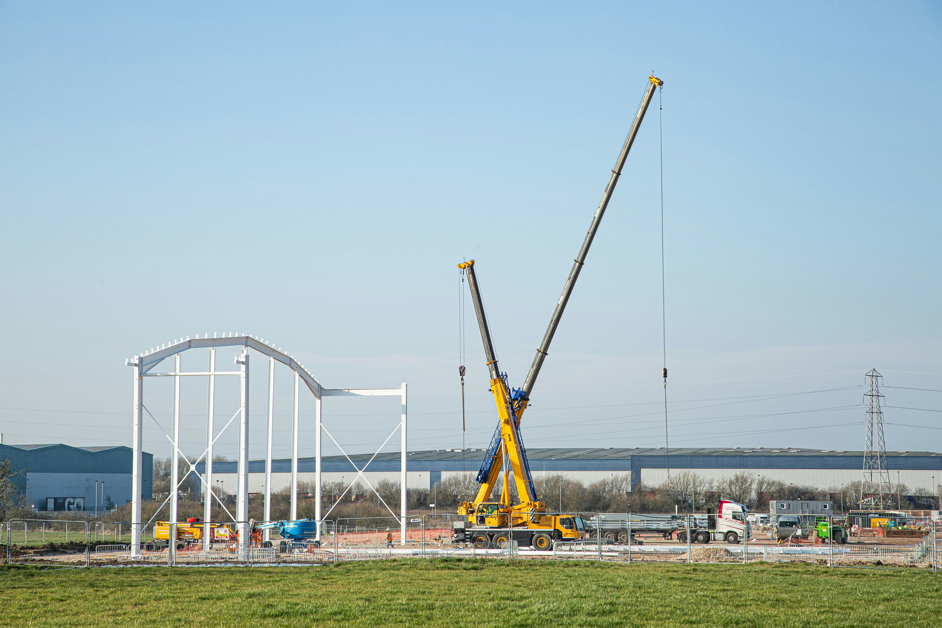 a large crane sitting on top of a lush green field