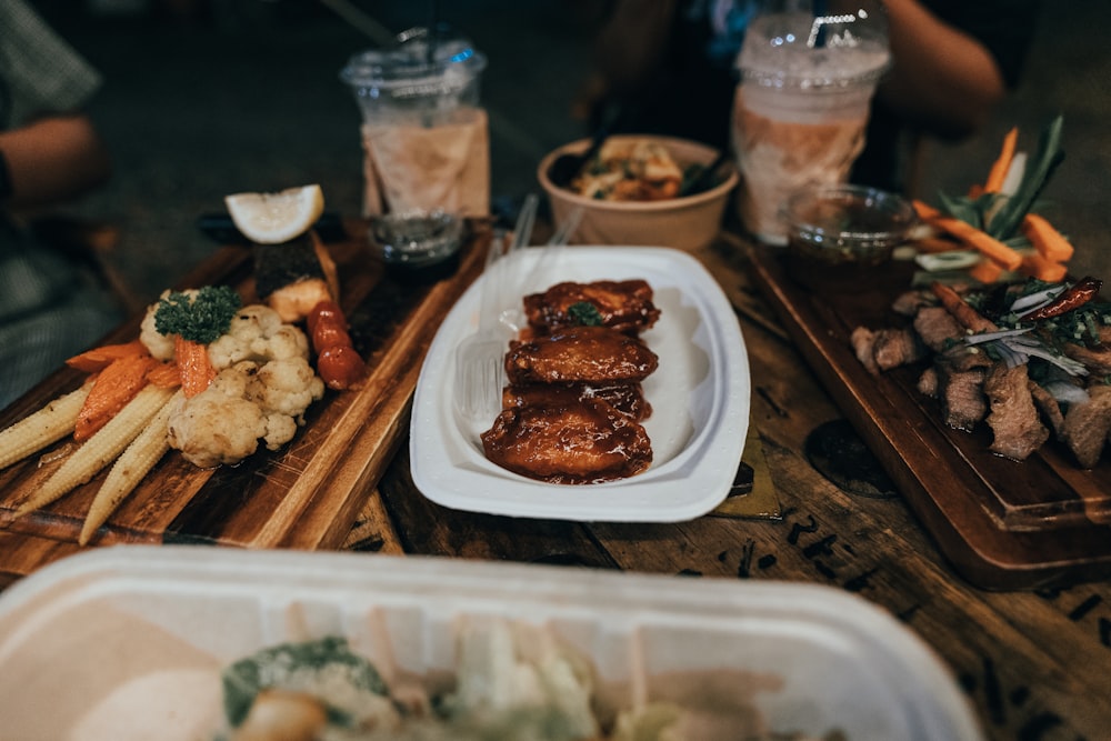 a wooden table topped with plates of food