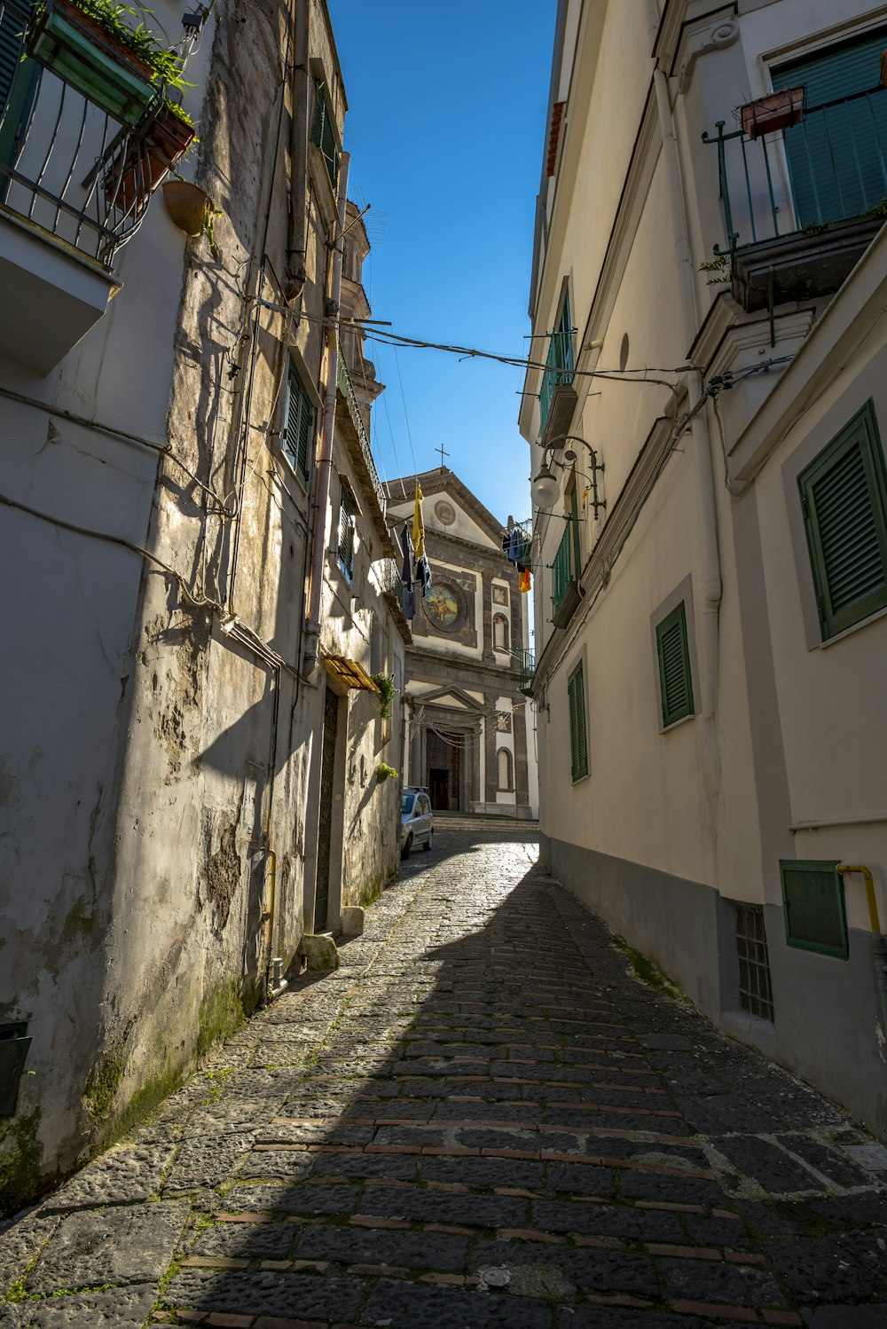 a narrow cobblestone street in a small town