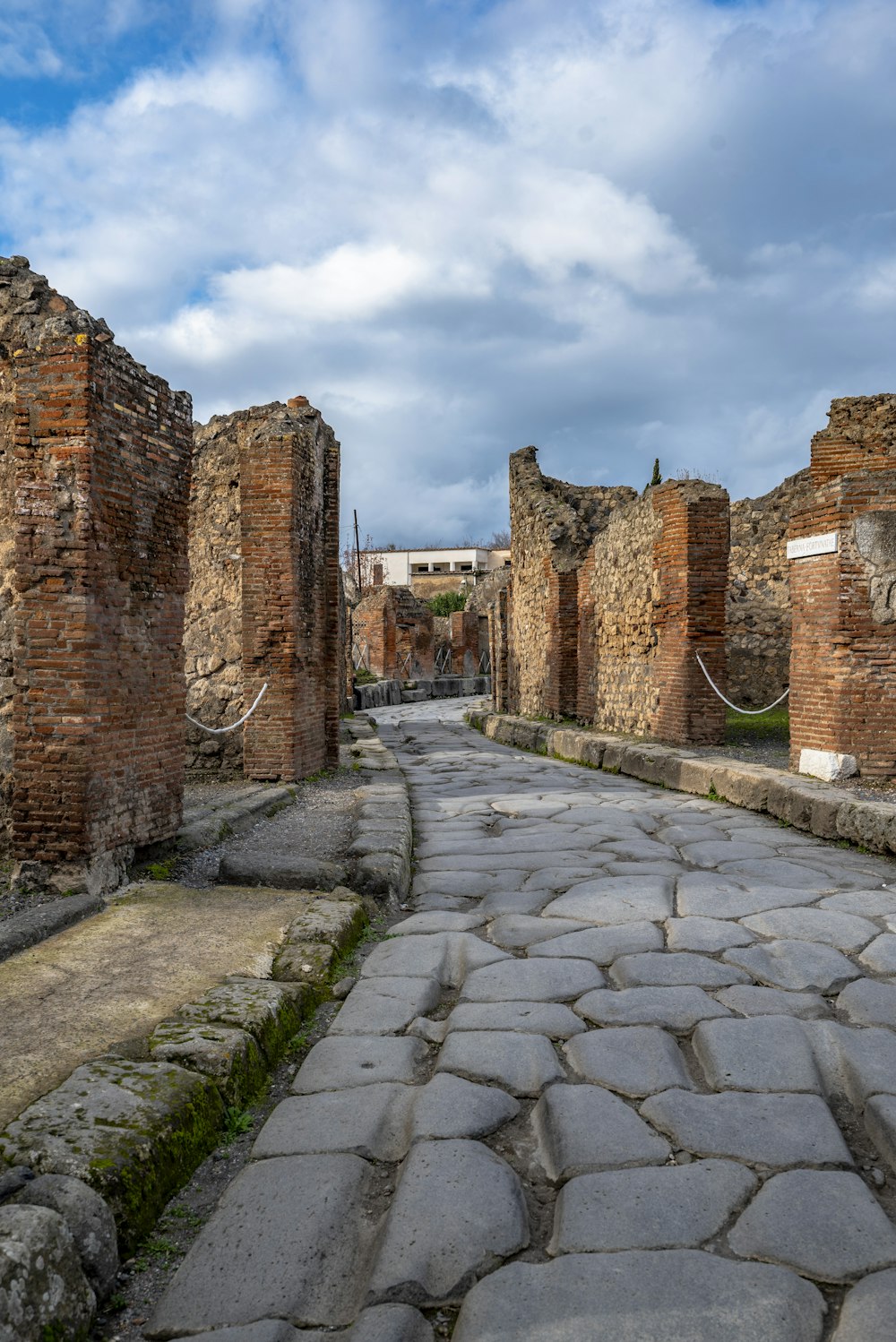 a cobblestone street lined with stone buildings