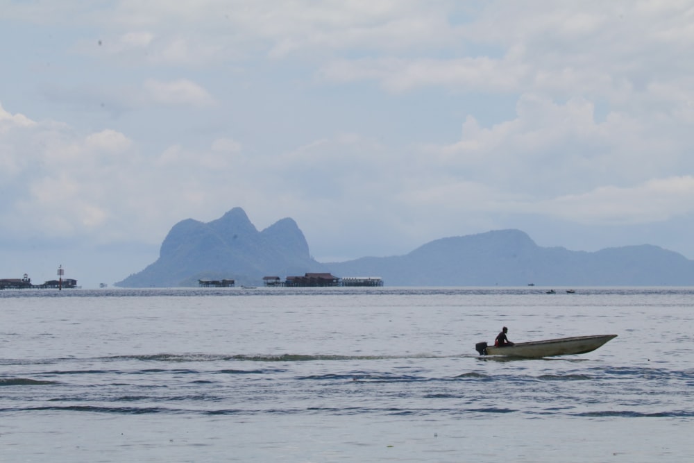 a person in a small boat in the water