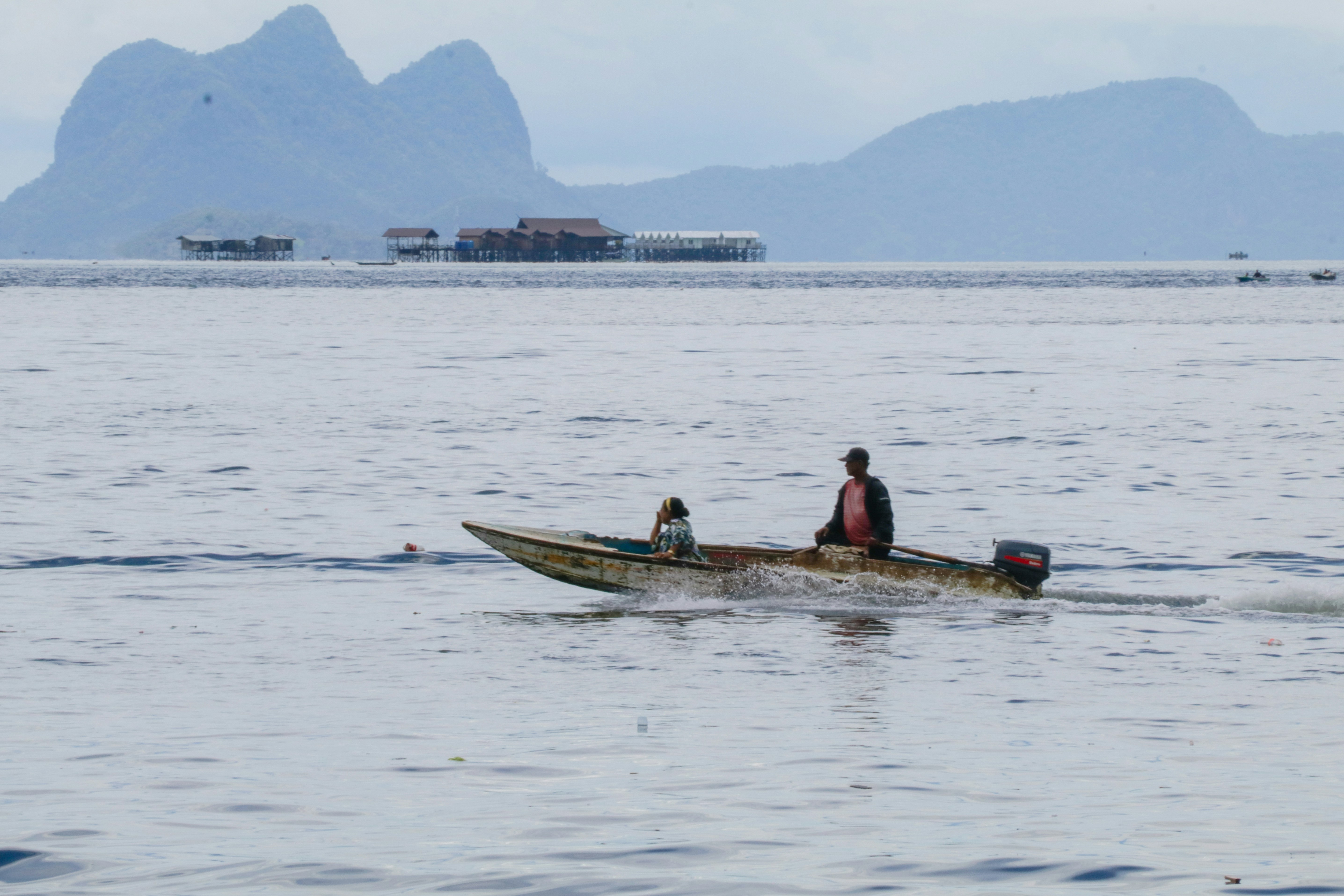 two people in a small boat on a body of water
