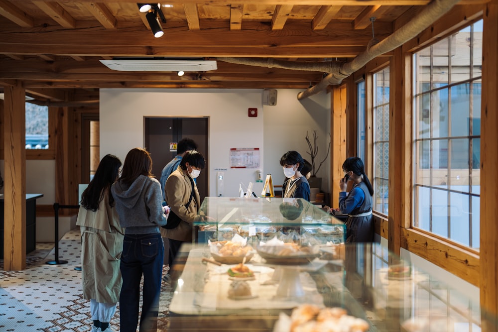 a group of people preparing food in a kitchen