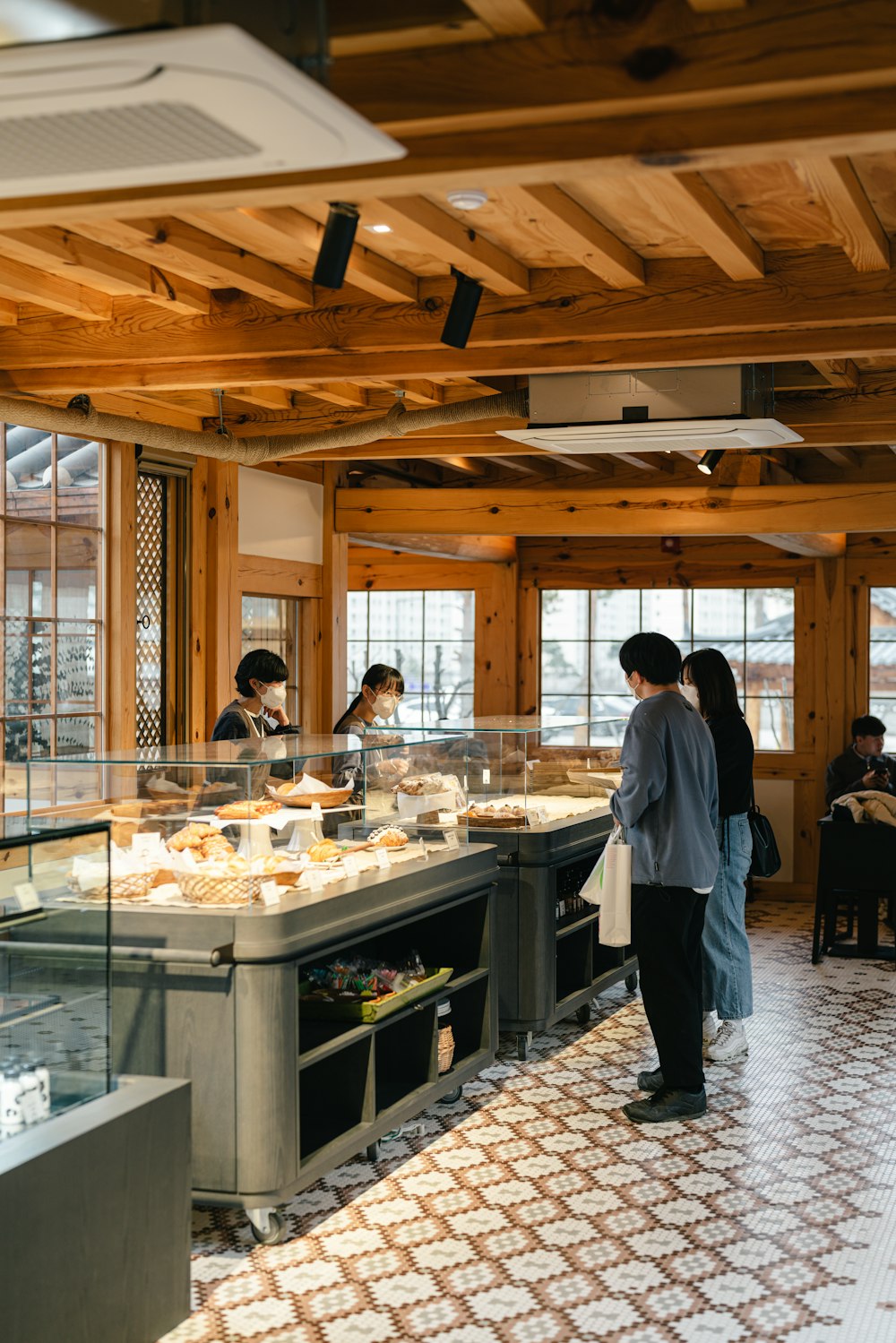 a group of people standing in a kitchen