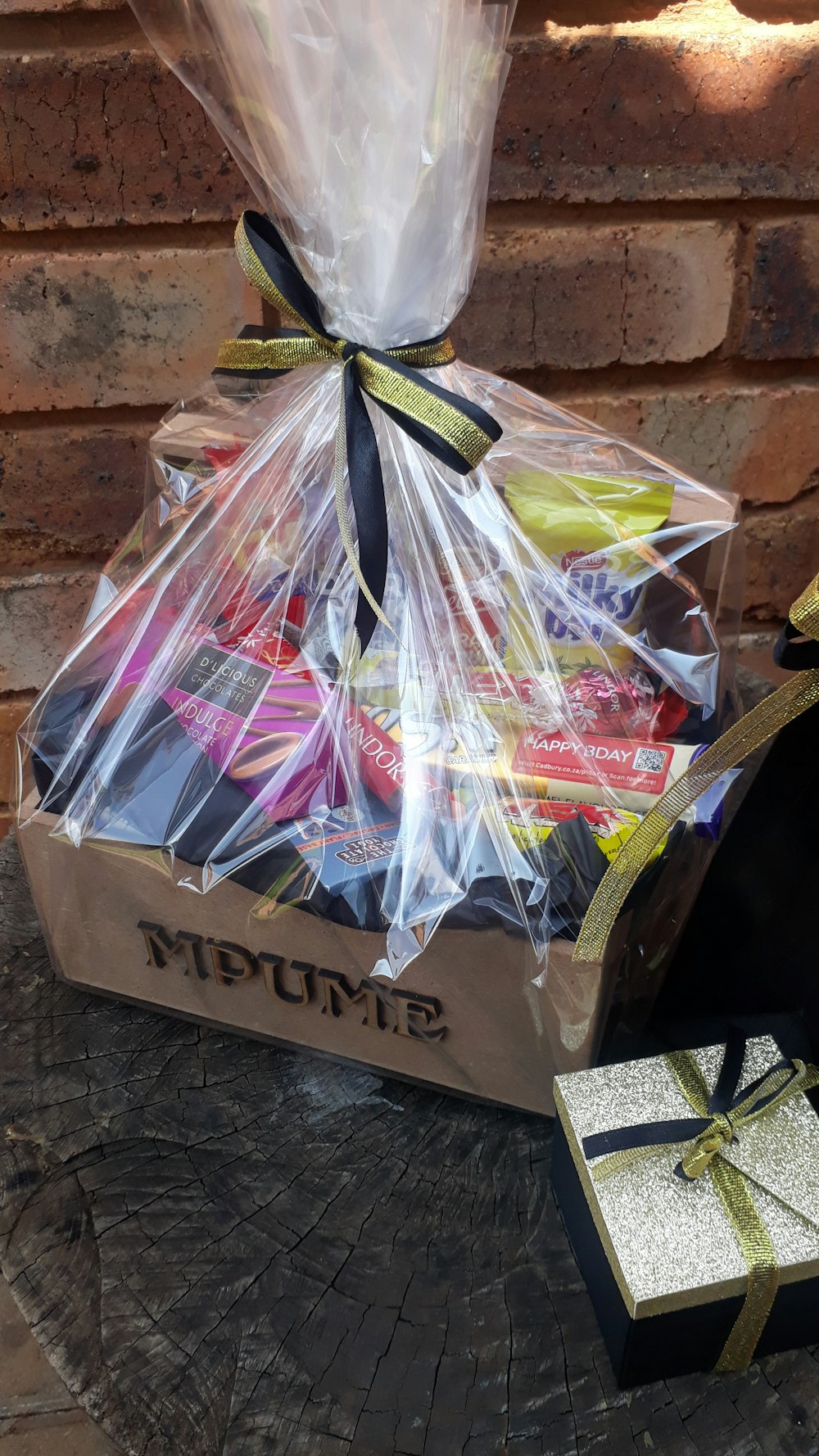 a wooden table topped with a gift box filled with candy