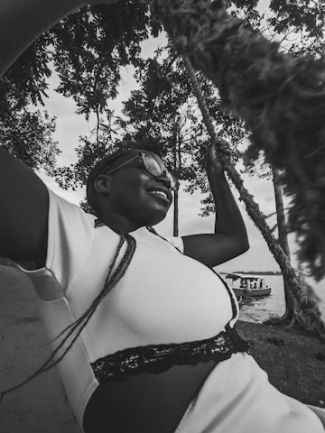 a black and white photo of a woman in a bikini