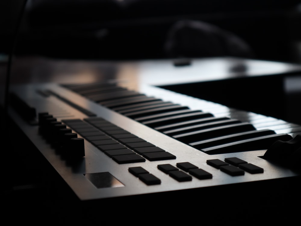 a close up of a piano keyboard in a dark room