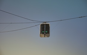 a traffic light sitting on top of a power line