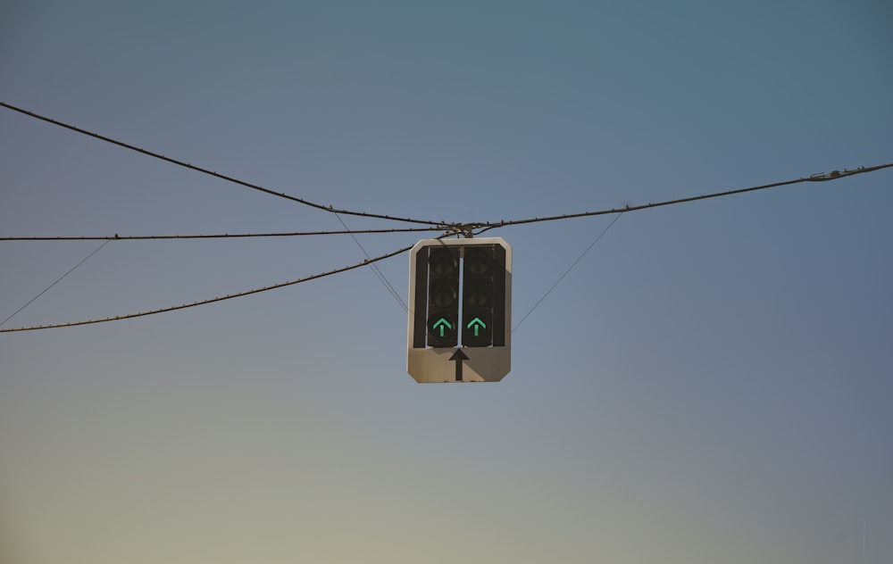 a traffic light sitting on top of a power line