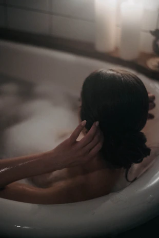 A comfortable jacuzzi bubbling gently, surrounded by calming candles.