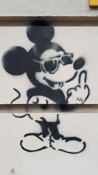 A cute and cheeky cartoon cat wearing a colorful t-shirt with a witty phrase.