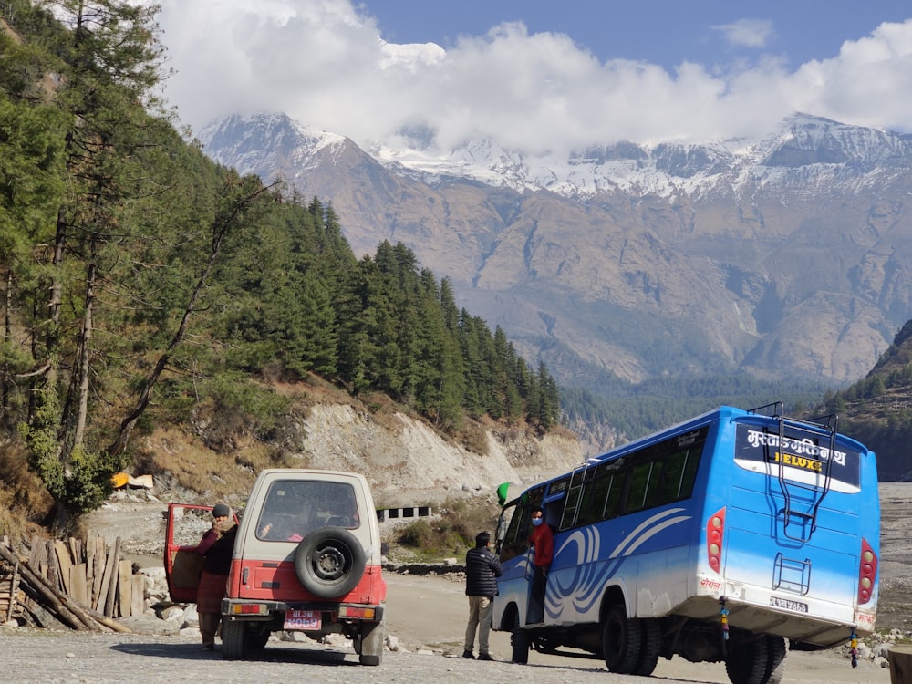 a blue van parked next to a white van