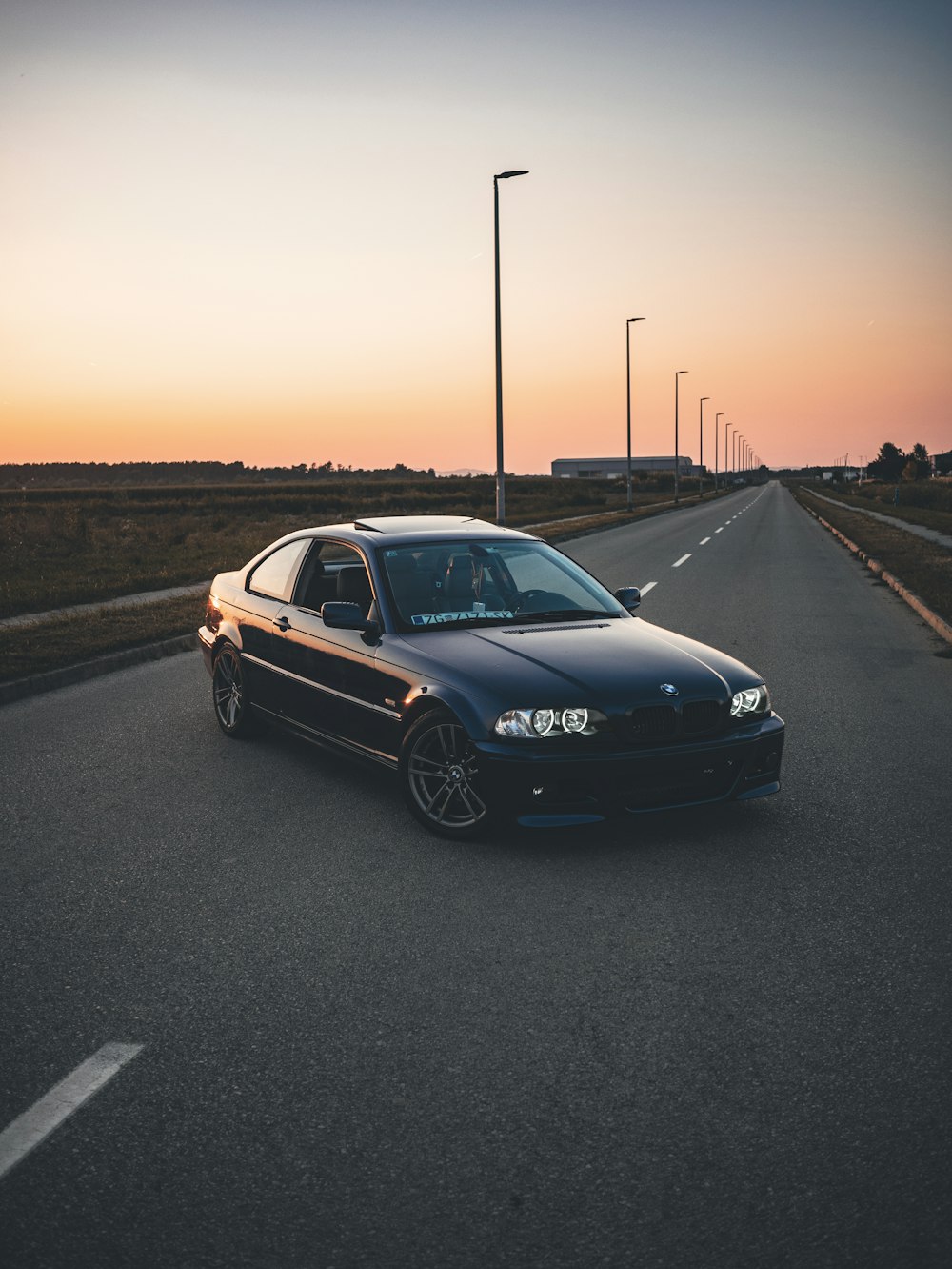 a black car parked on the side of a road