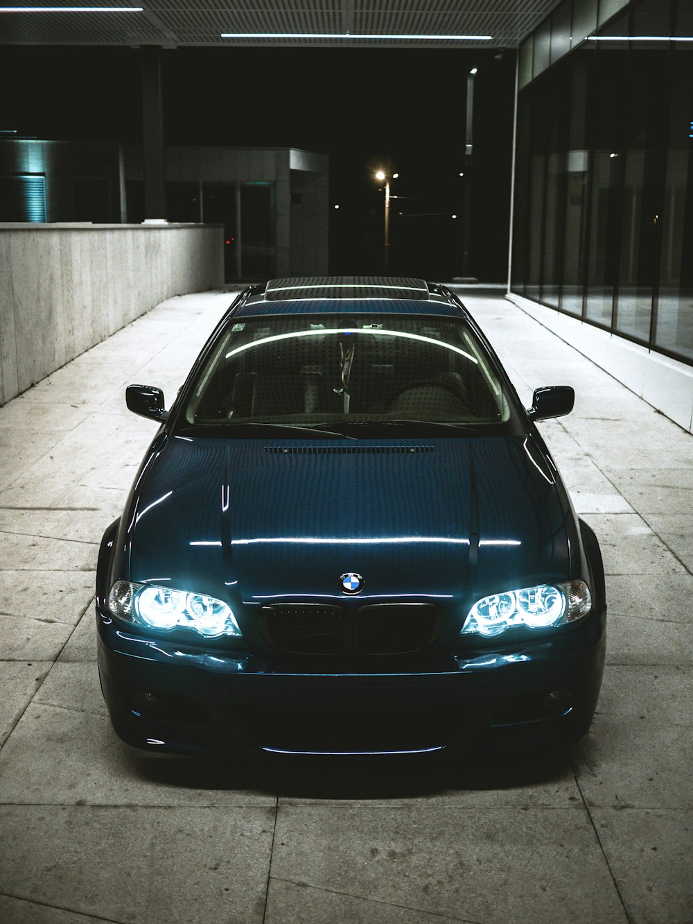 a blue car parked in a parking garage