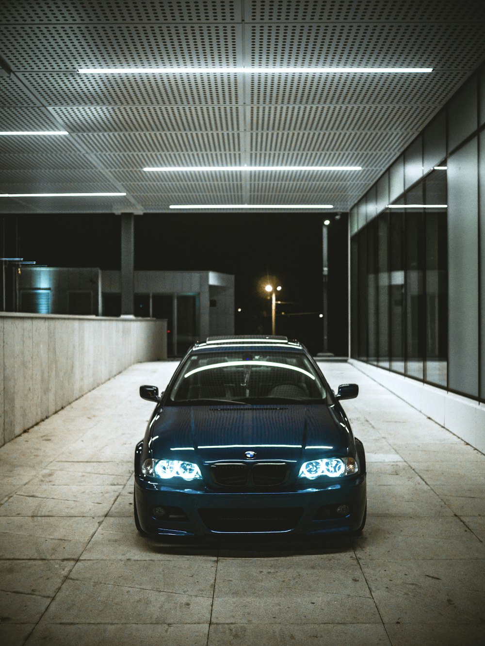 a blue car parked in a parking garage