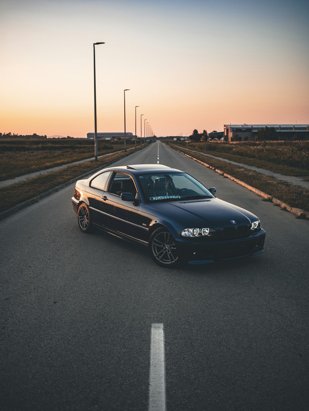 a black car parked on the side of a road