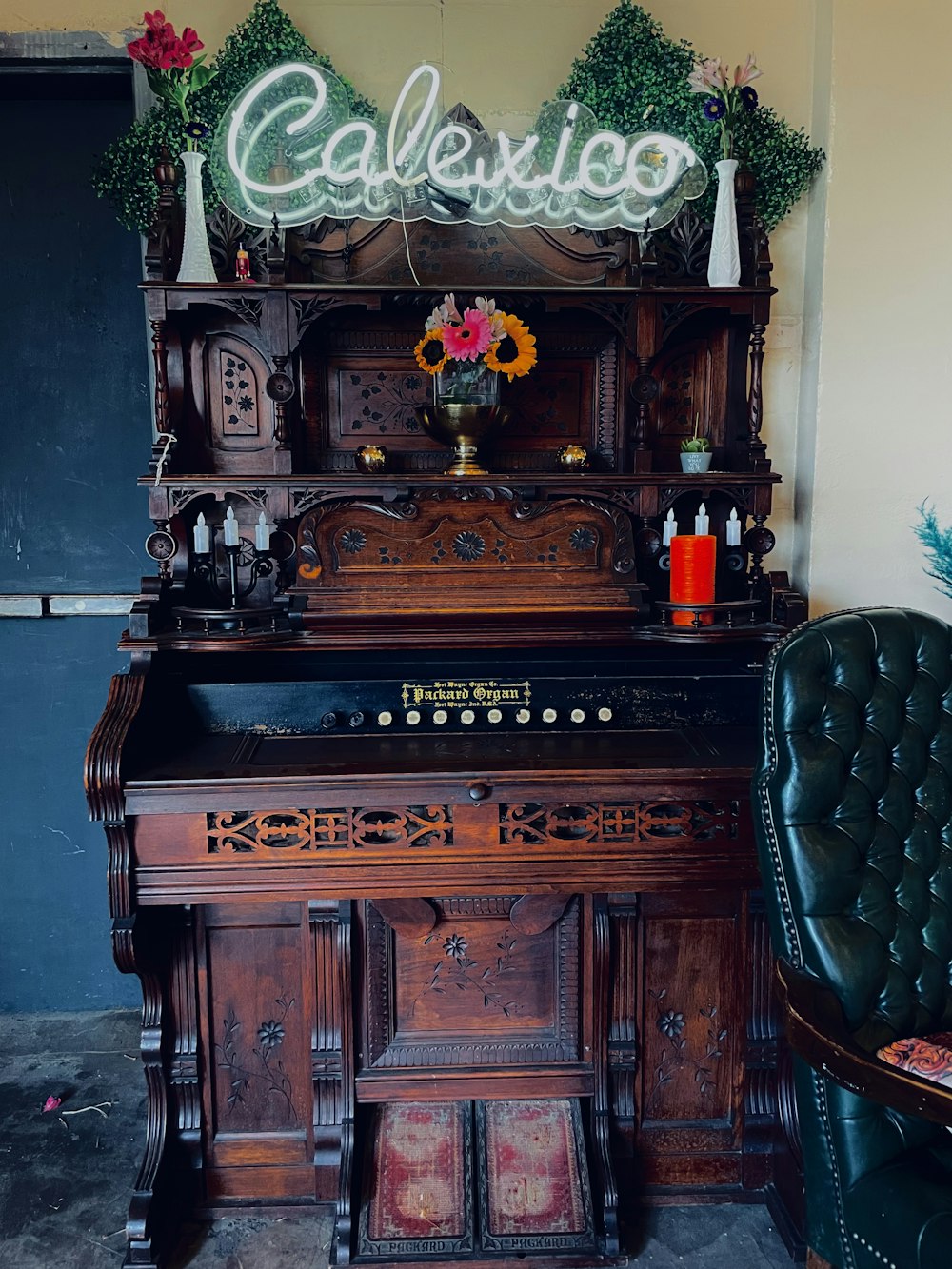 a piano sitting in a room next to a chair