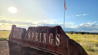 A rustic audio-video guestbook setup glowing warmly against the red desert sunset in Alice Springs.