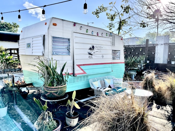 a trailer parked in a backyard next to a pool