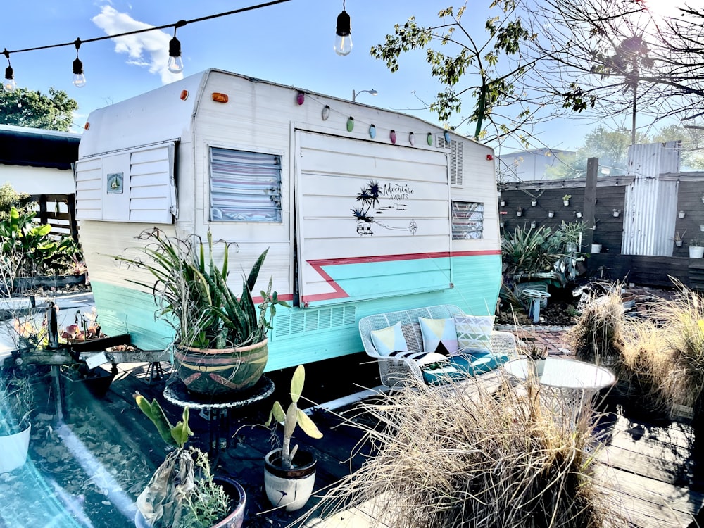 a trailer parked in a backyard next to a pool