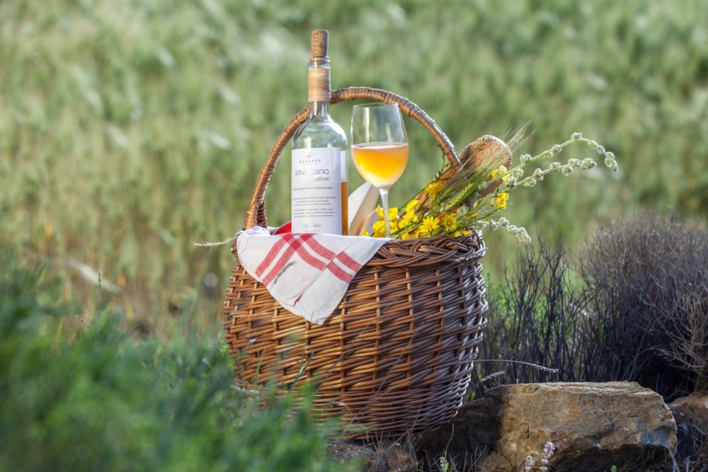 a bottle of wine sitting in a basket next to a bottle of wine