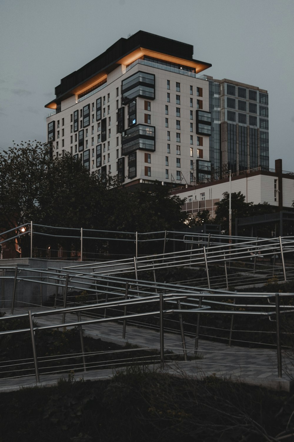 a building with a lot of windows next to a walkway