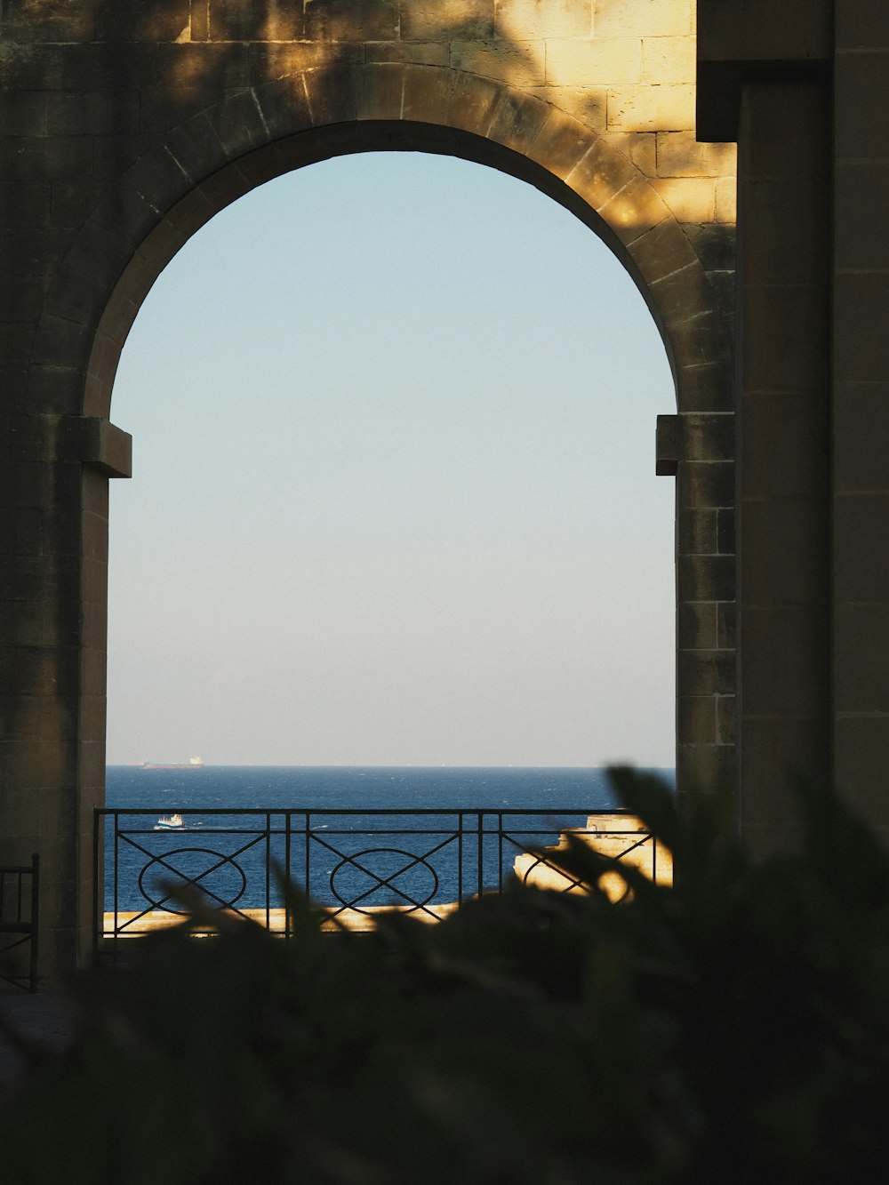 a view of the ocean through an archway