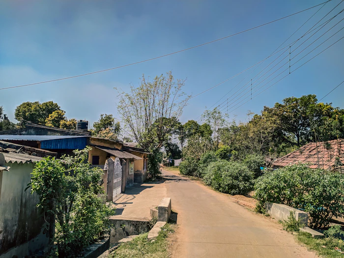 A rural Indian village road with houses