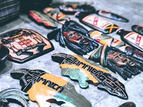 a bunch of beer bottle openers sitting on the ground