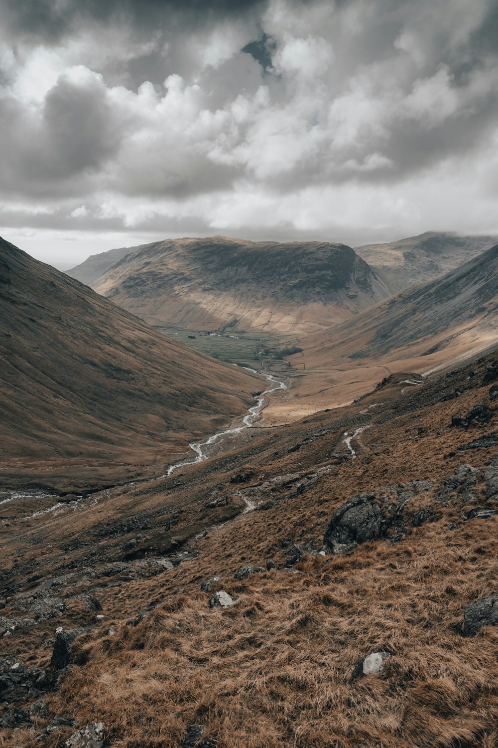 a view of a valley with a river running through it