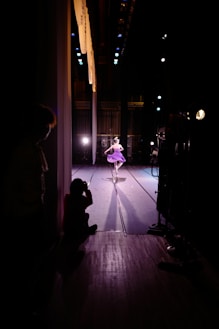 a person in a dark room with a light on