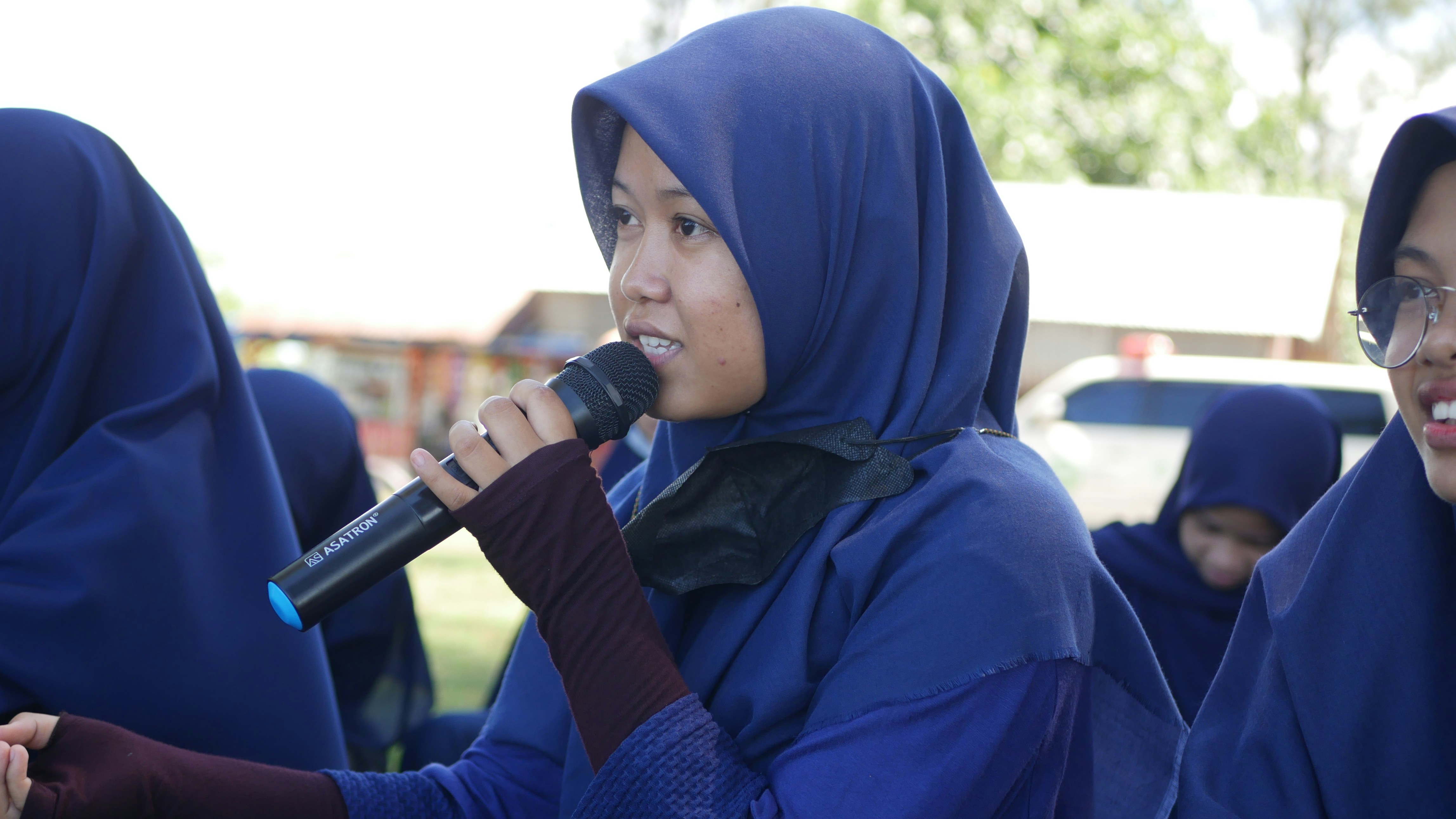 Women in hijabs singing
