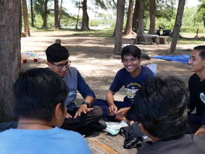 a group of young men sitting on top of a picnic table