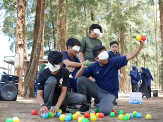 a group of people playing with balls in the woods