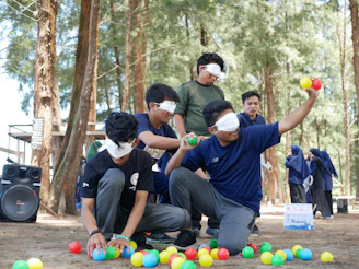 a group of people playing with balls in the woods