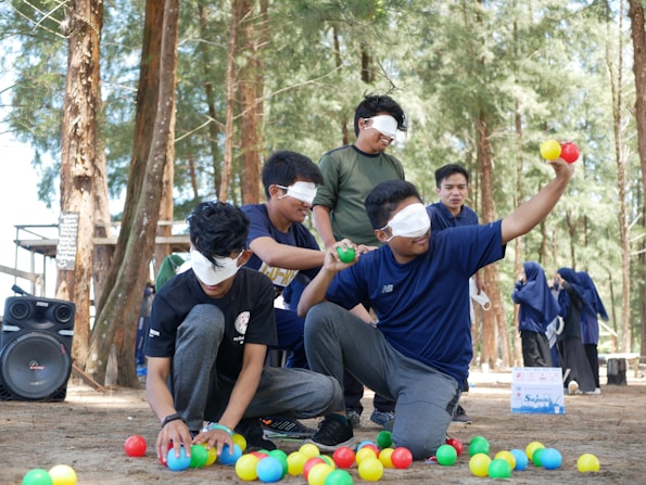 a group of people playing with balls in the woods
