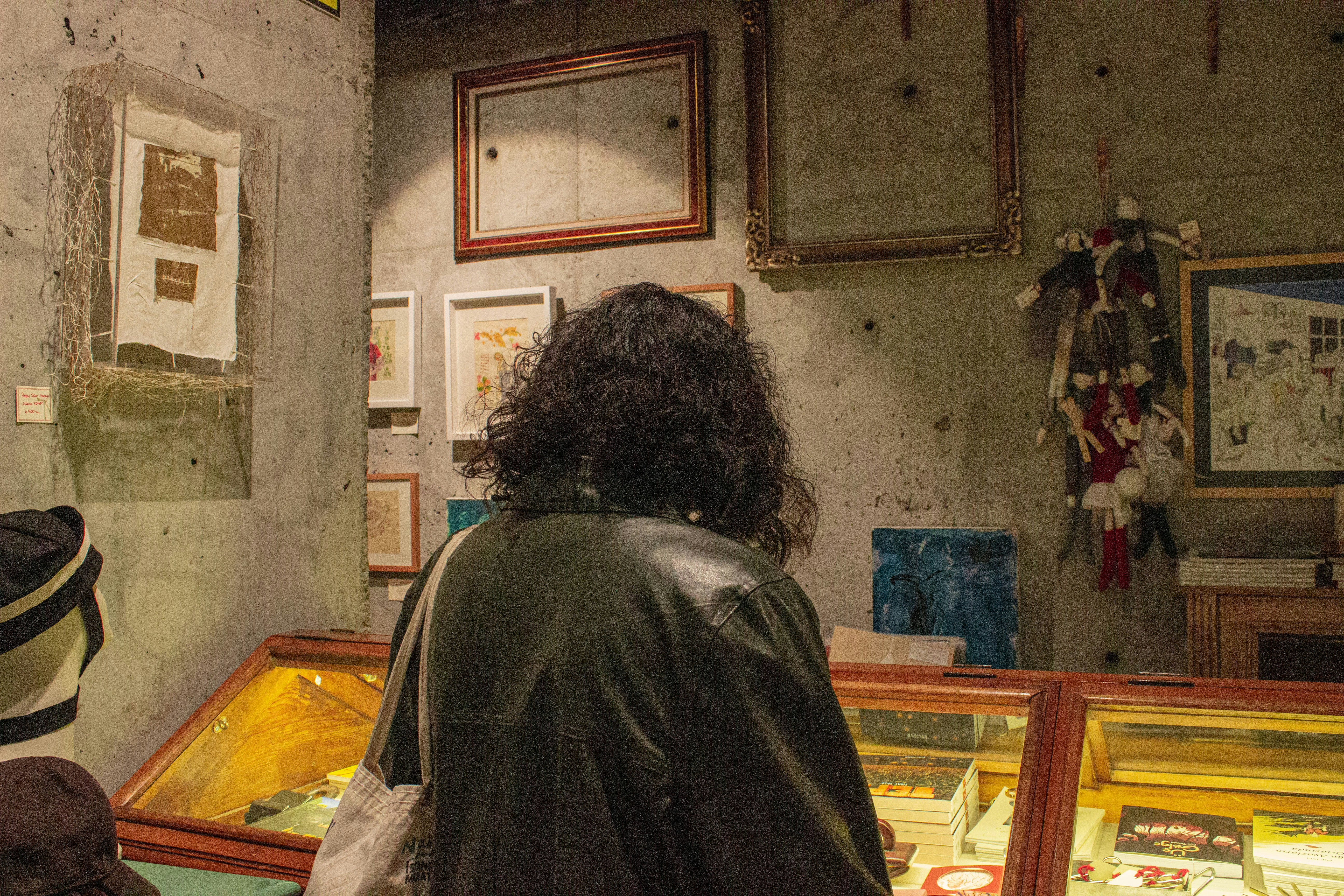 a woman looking at a display case in a museum