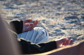 a close up of a person laying in the sand